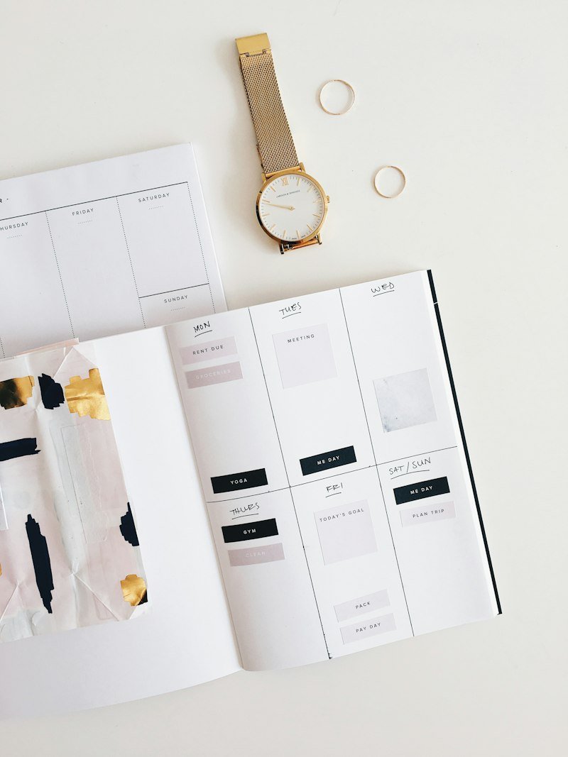 Weekly planner and gold watch for event and RSVP planning